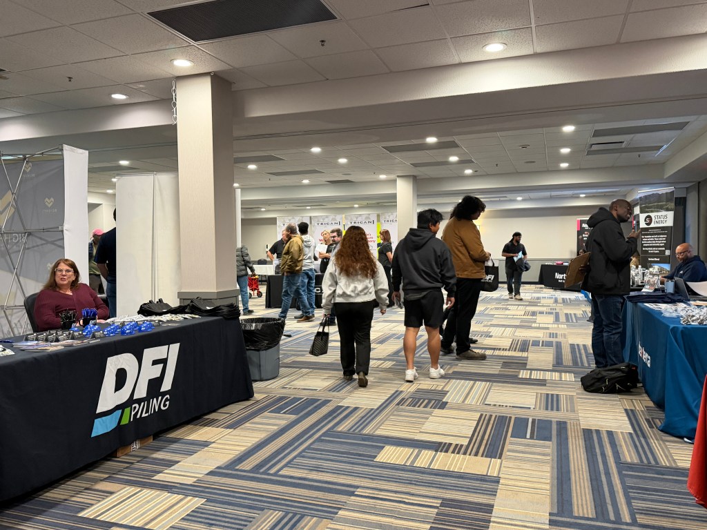 Attendees walking between employer booths at the Grande Prairie Job Fair